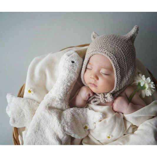 Small hot water bottle in the shape of a cuddly white goose