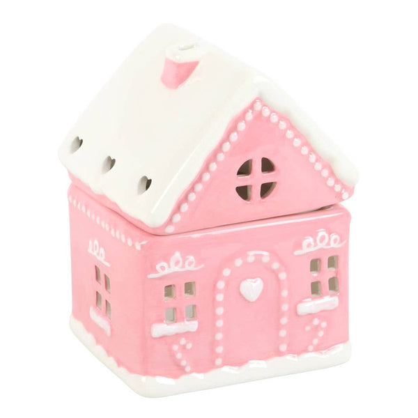 Roze peperkoekhuisje kerstoliebrander