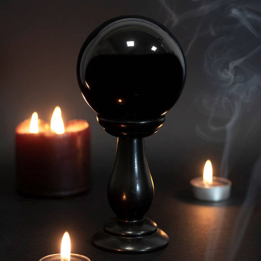 Small black crystal ball on a stand