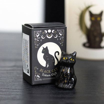 Set of 24 black cat tokens on a display stand
