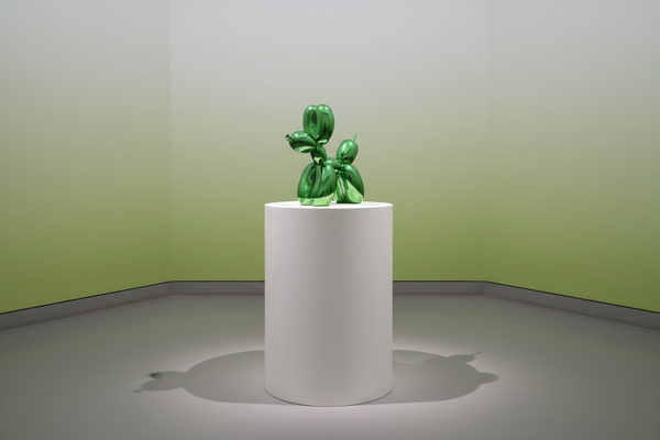 Large decorative figurine of a dog with an electric green balloon.
