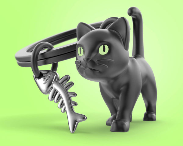 Sleutelhanger met een zwarte kat en fosforescerende ogen.