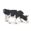 Figurine Vache noire et blanche broutant