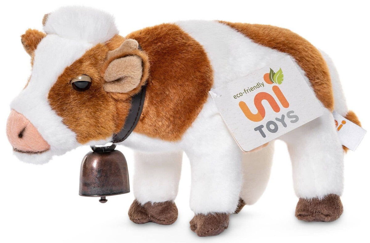 Standing white and brown cow plush toy with bell