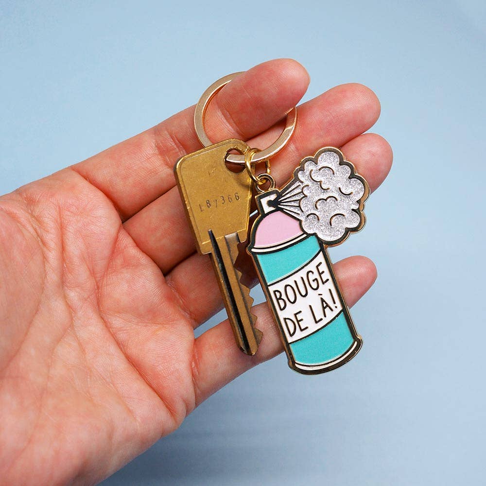 Sleutelhanger met de tekst "Verhuis hier weg"