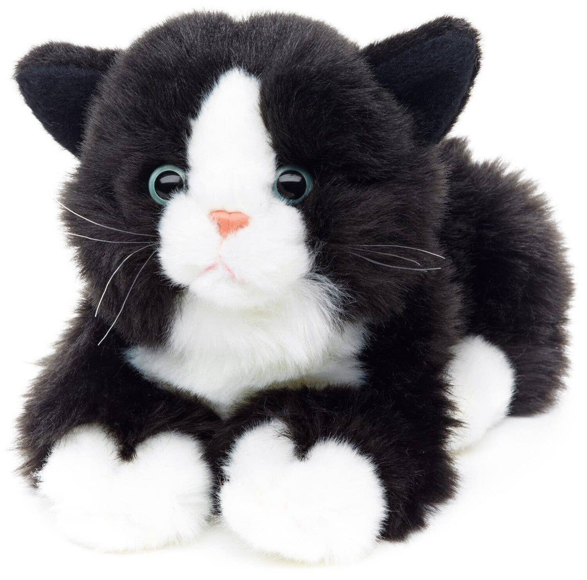 Black and white cat plush, lying down