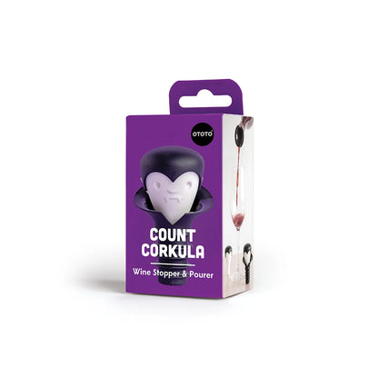 Purple box of OTOTOs Count Corkula wine stopper with a vampire design for wine lovers.