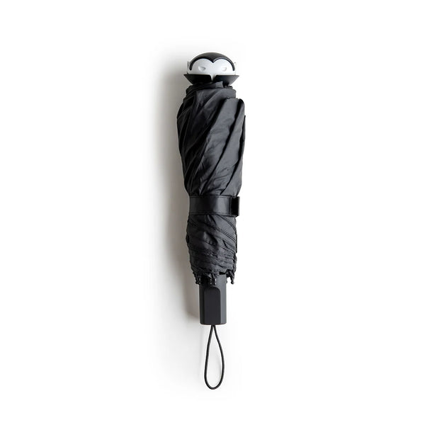 Stylish Spookula umbrella by OTOTO, features a penguin handle and wrist strap, on a white background.