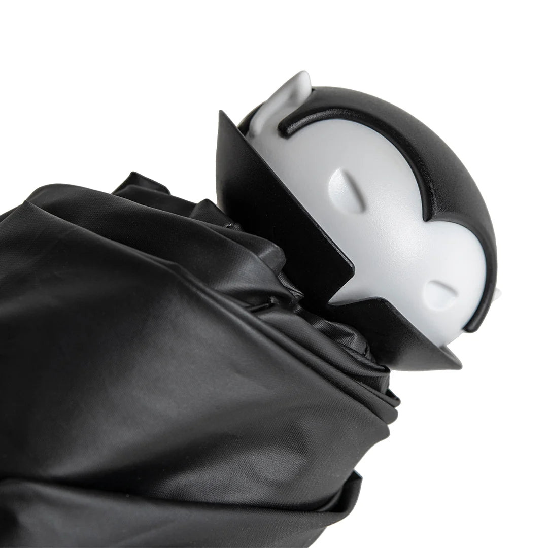 Spookula: A black-and-white vampire figure with closed eyes, wrapped in black cloth.